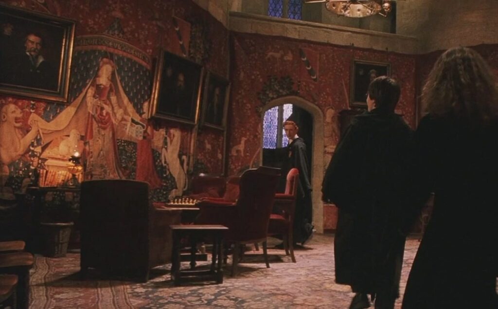 This image depicts a scene from one of the Harry Potter movies, in which a room is decorated with a wallpaper pattern of the Lady and the Unicorn tapestry series. It is included as an example of medieval tapestries found in pop culture.