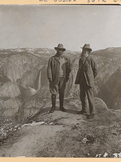 Decorative image. Theodore Roosevelt and John Muir pose at the edge of the Glacier Point cliff in Yosemite Valley.